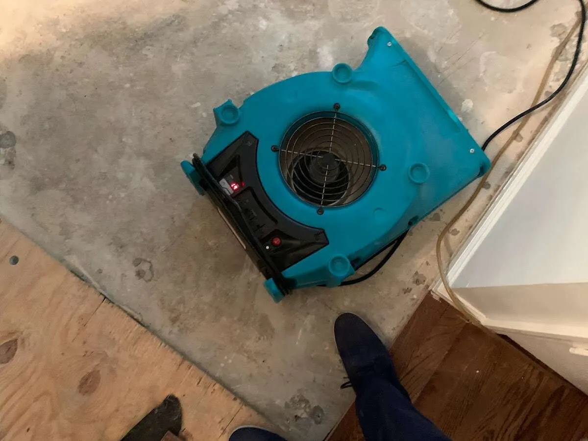 Air mover drying subfloor during Commercial Water Damage Restoration in Trotwood